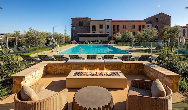 Vasari pool with lounge chairs and a firepit